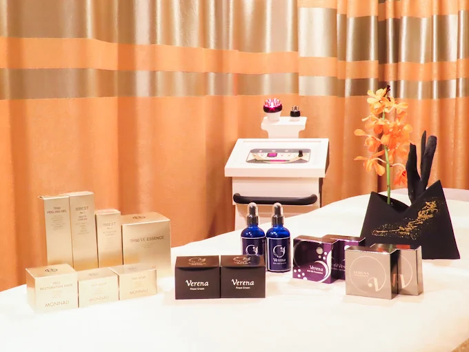 A softly lit treatment room with a neatly prepared treatment bed and towels